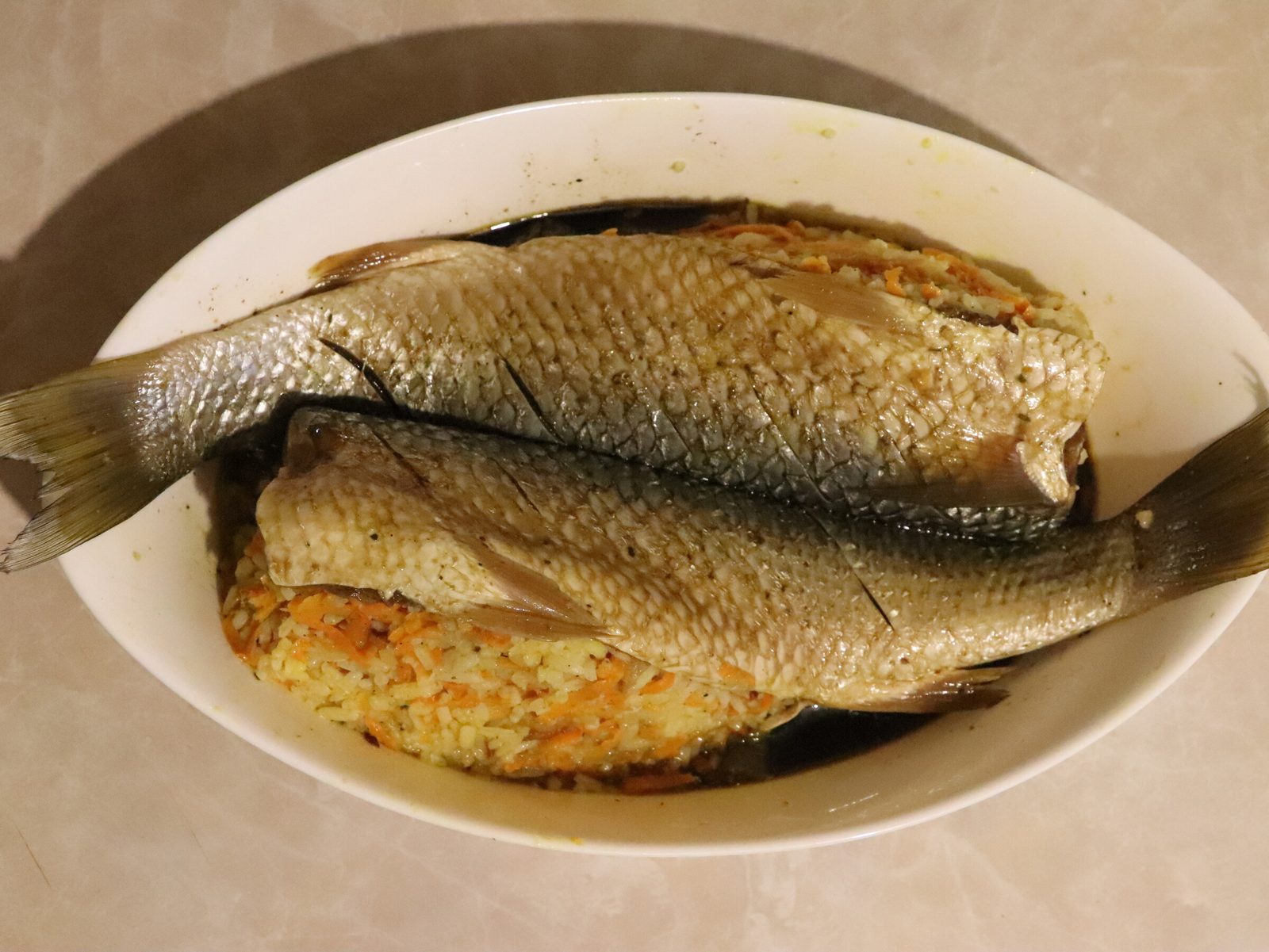 Step 5. Place the fish in a baking dish and stuff it with rice filling. Baked stuffed grey mullet