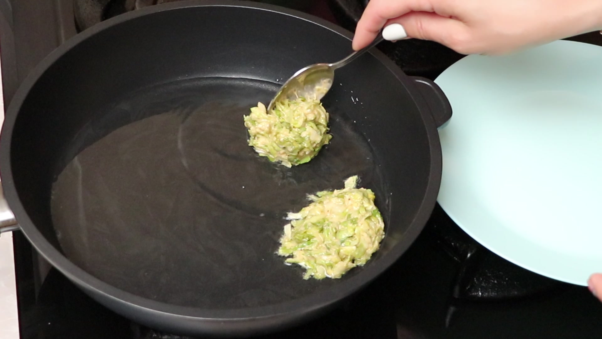 Step 5. Using a tablespoon or dessert spoon, spoon the cabbage batter into the pan. Cabbage fritters for the whole family