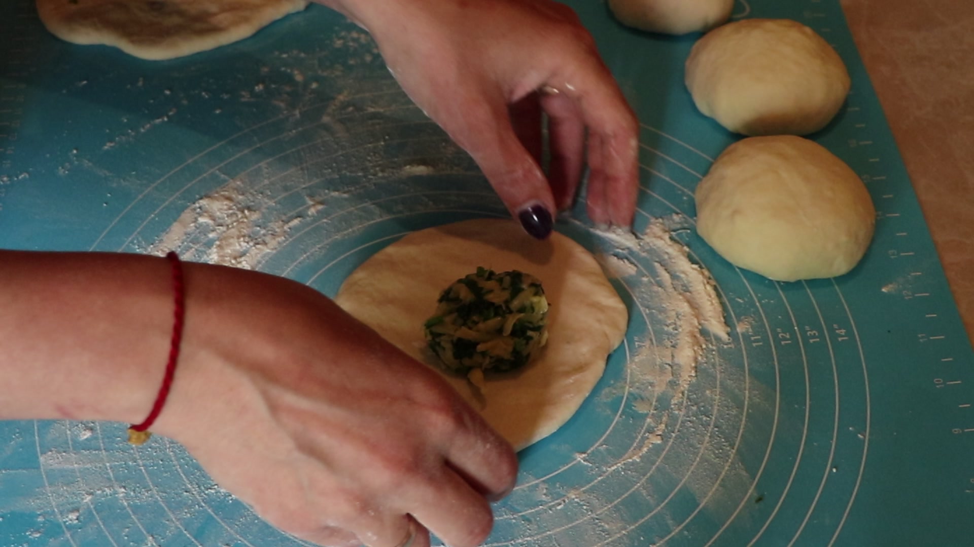 Step 8. Ball each piece and stretch or roll a small round, larger than the filling ball. Cheese and spinach flatbreads (khychiny)