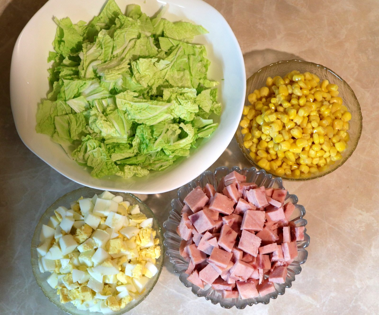 Step 3. Add corn to them and season with mayonnaise. Chinese-leaf salad with ham