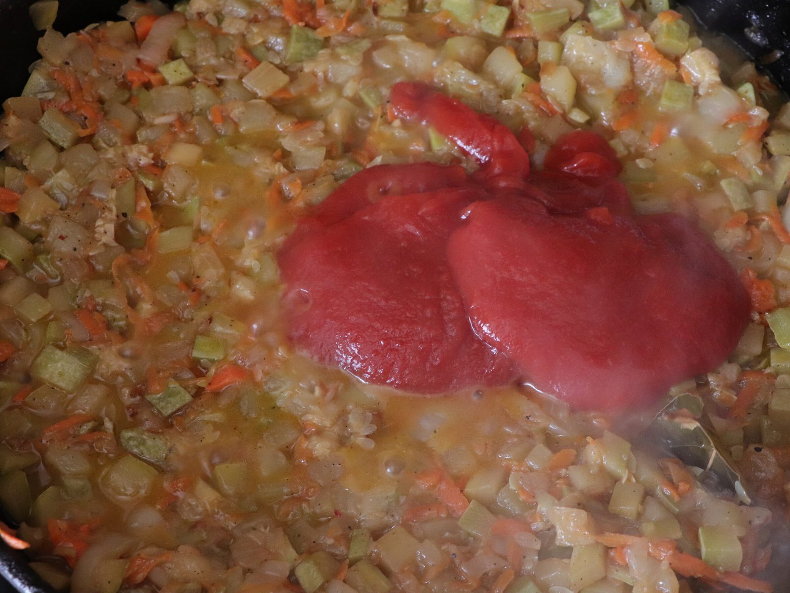 Step 7. When almost all the liquid has evaporated, add tomato paste and fry everything. Courgette caviar