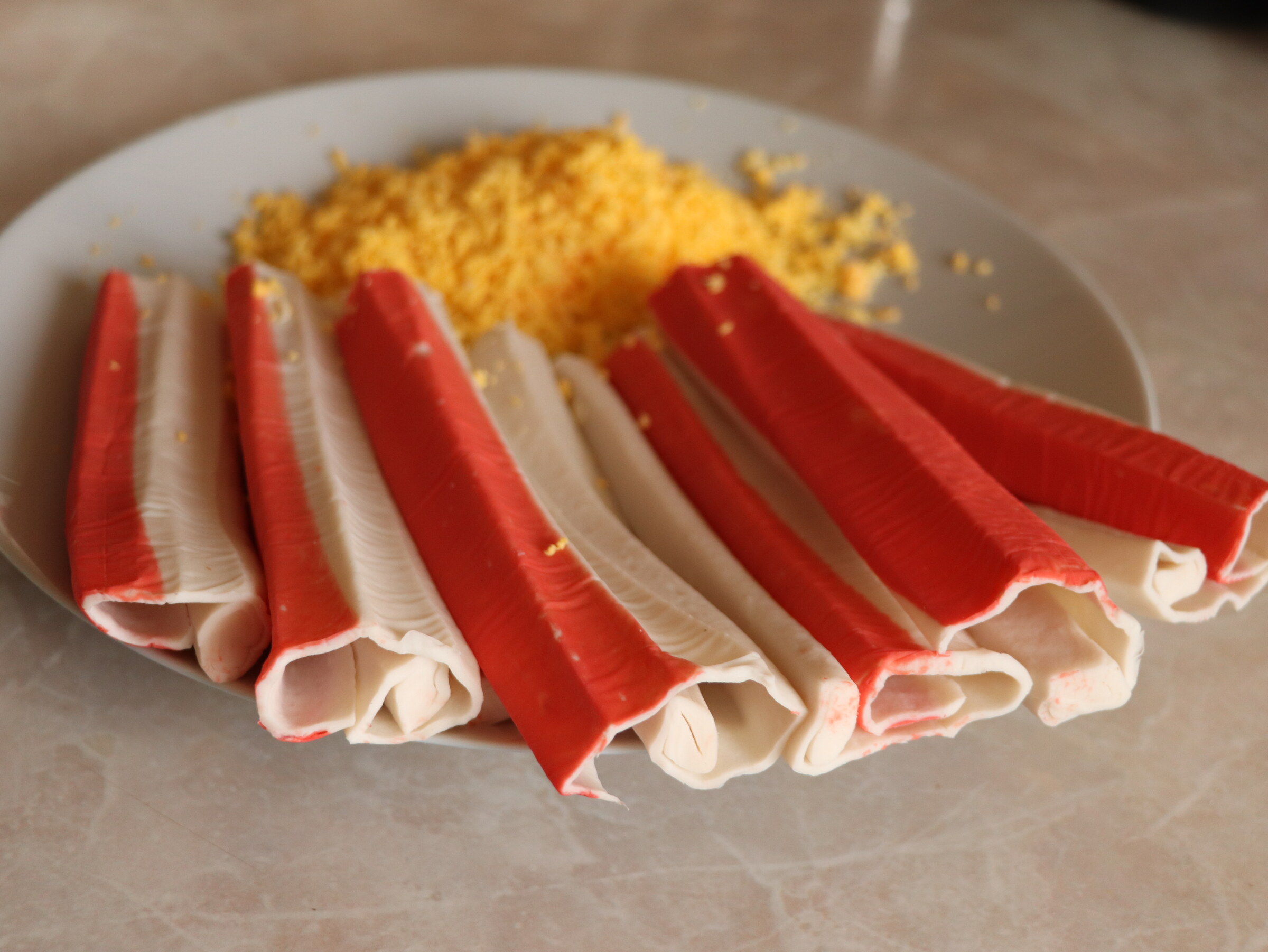 Step 2. Thaw the crab sticks and unroll each into a rectangle. Crab-stick starter