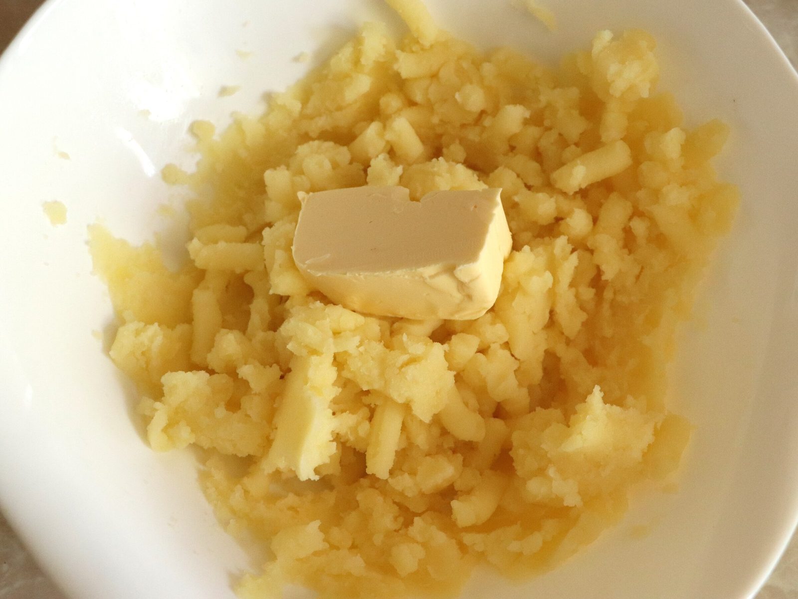 Step 5. Take the boiled potatoes out of the broth and mash them until smooth in a way. Creamy melted-cheese soup