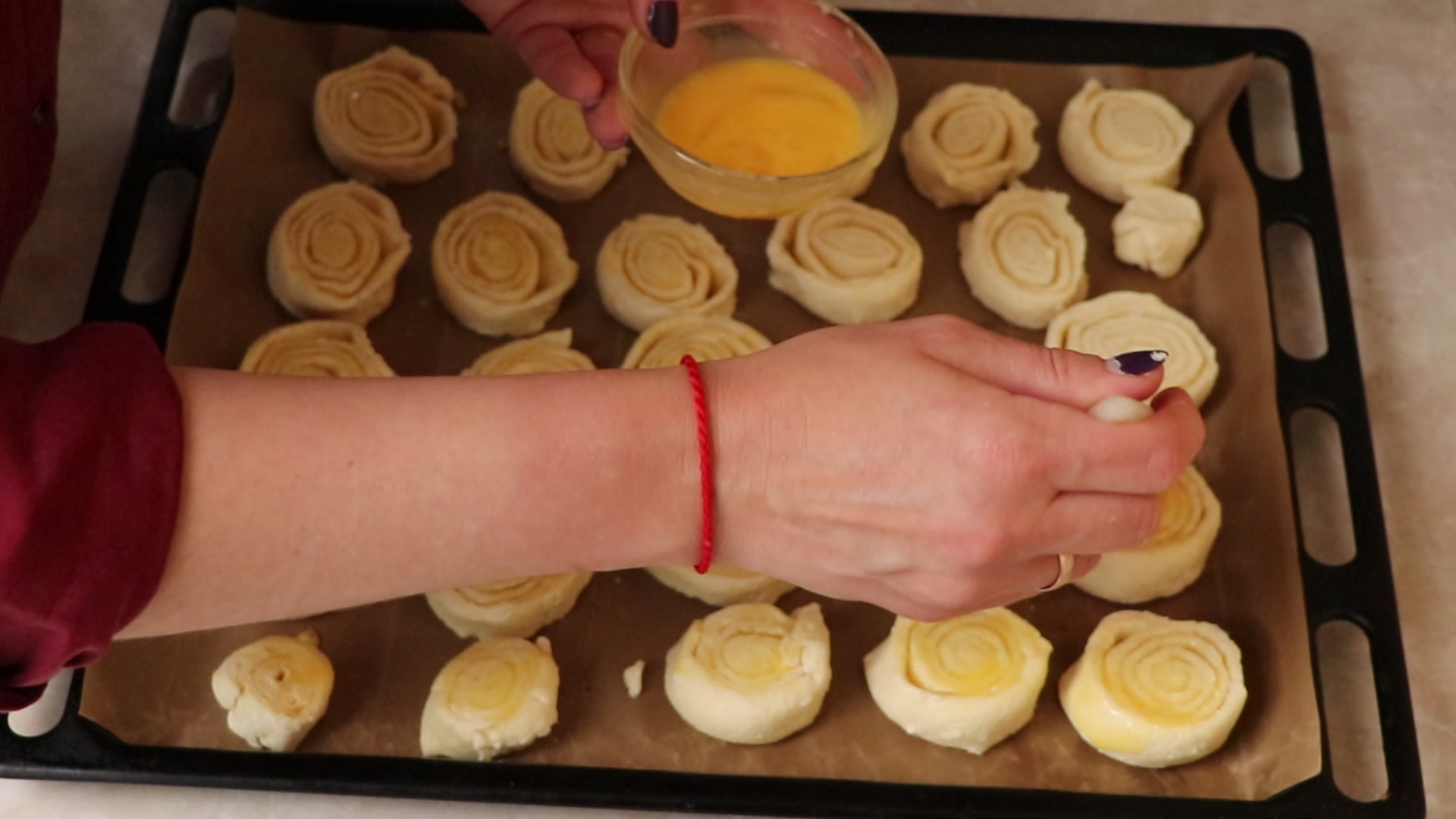 Step 8. Brush the top with beaten egg. Curd-cheese snail biscuits
