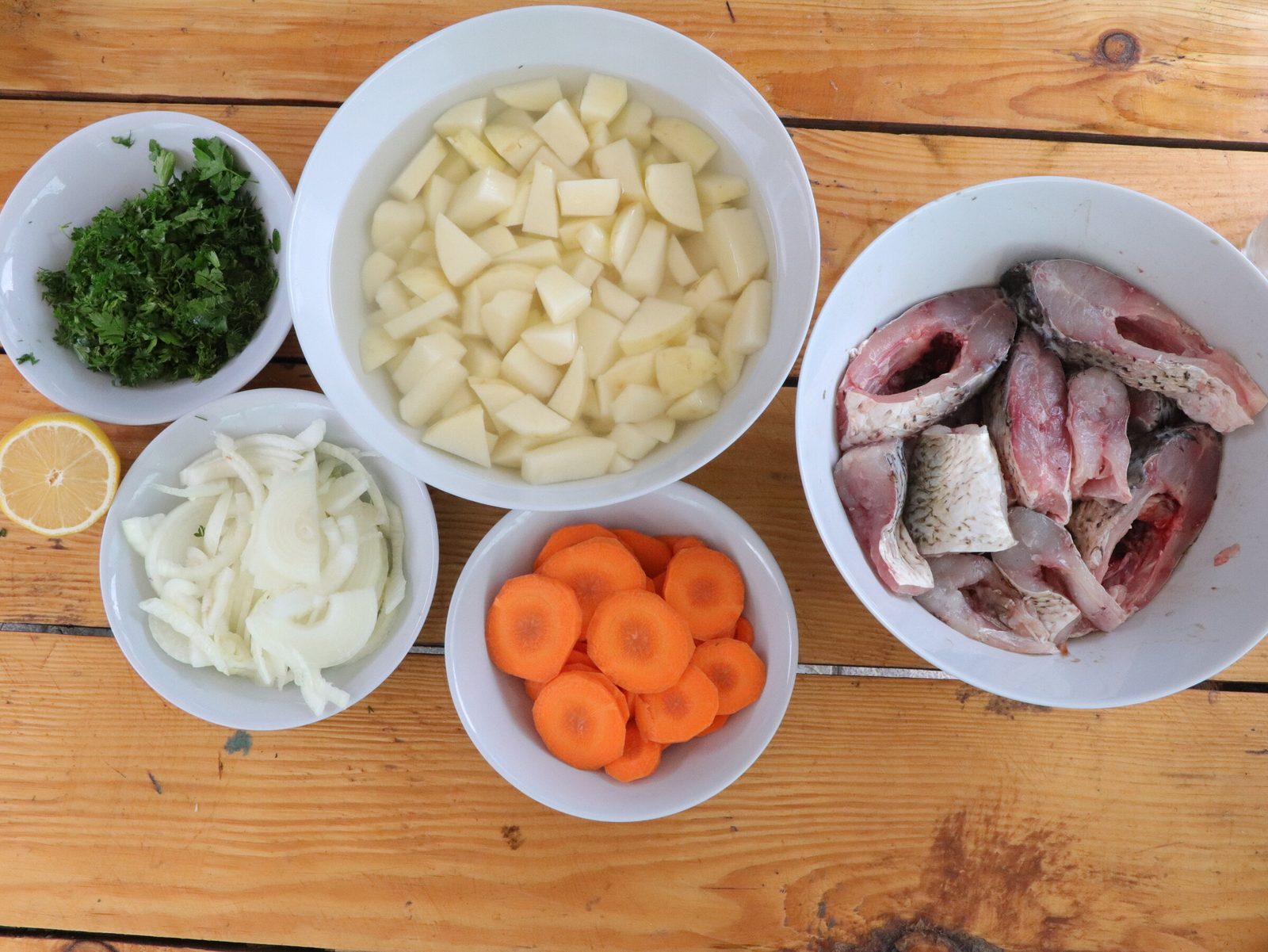 Step 5. Next, add onions and carrots to the cauldron. Fish broth (ukha) in a kazan
