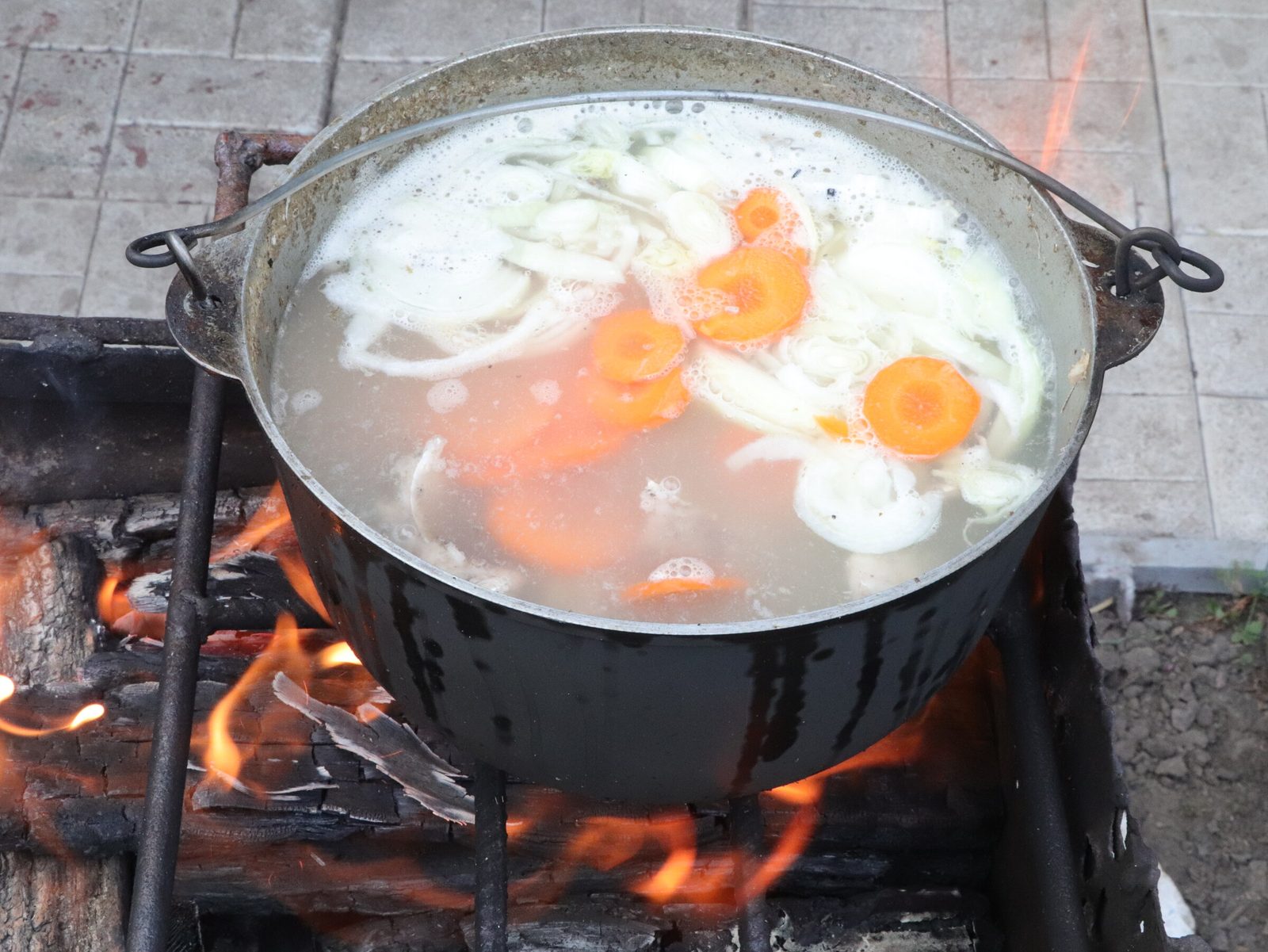 Step 7. When the potatoes are ready, remove from the heat and add the chopped greens to. Fish broth (ukha) in a kazan