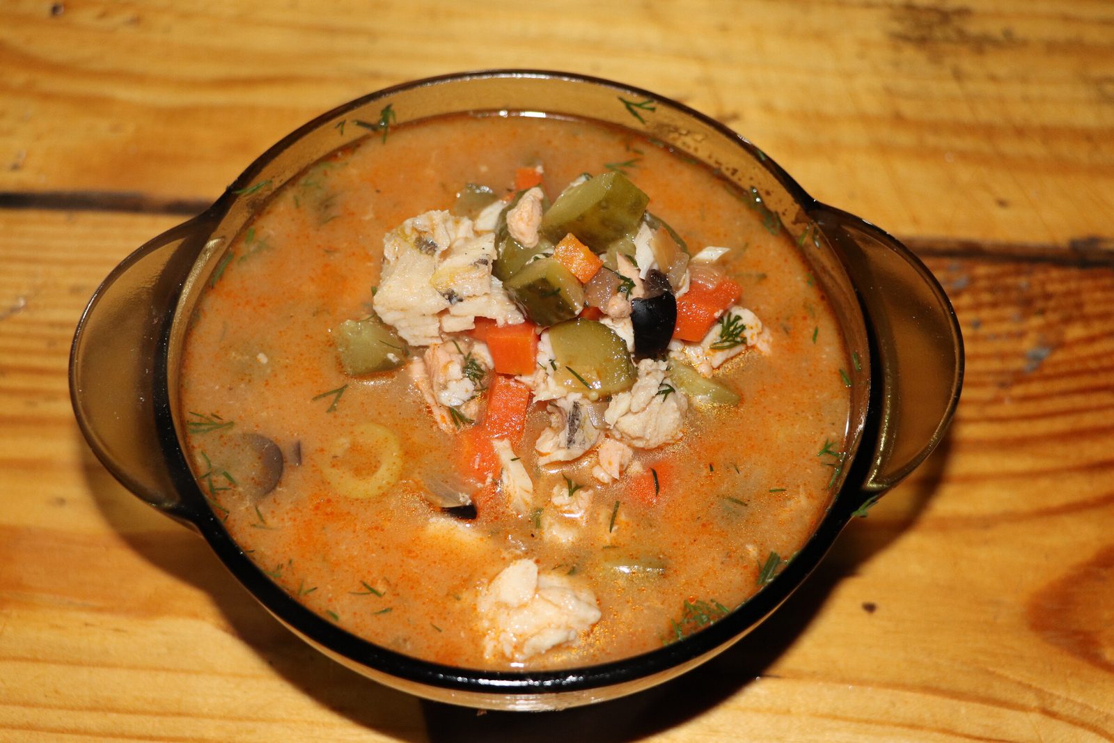 Fish solyanka in a kazan over the fire