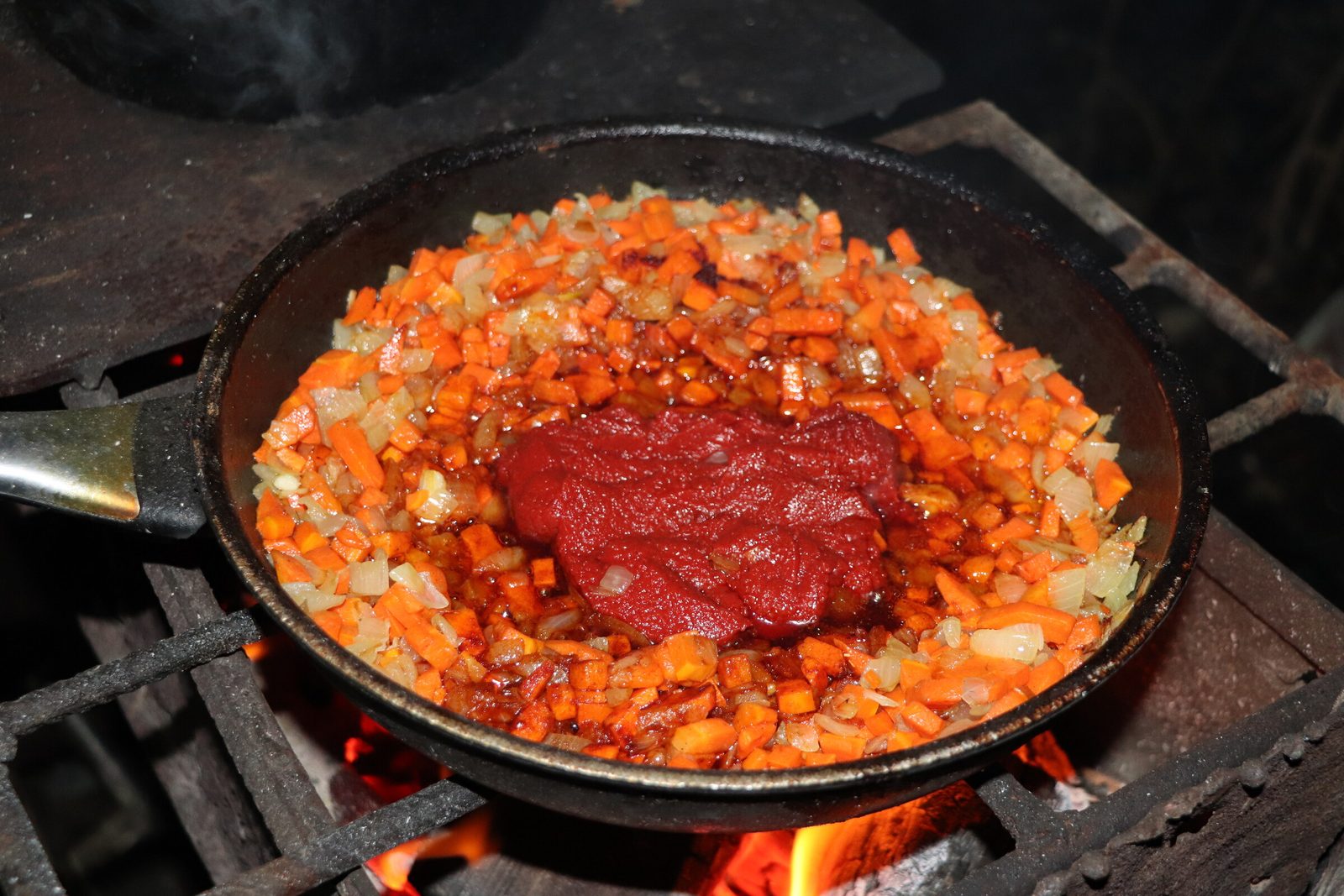 Step 5. We start preparing a delicious fish solyanka with broth. Fish solyanka in a kazan over the fire