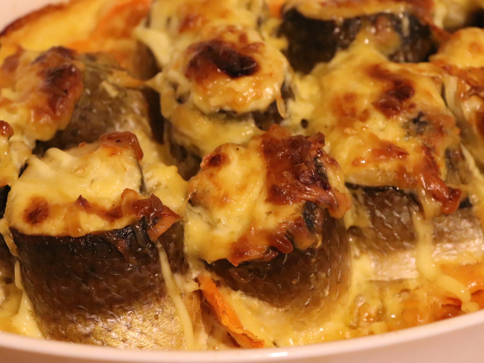 Step 6. Take a baking dish and pour a little olive oil (or any vegetable oil) into the. Grey mullet rolls with cheese on a bed of