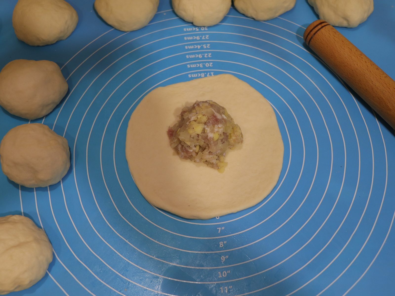 Step 3. Next, divide the dough into parts, form balls and roll out round cakes with a. Lazy meat triangles