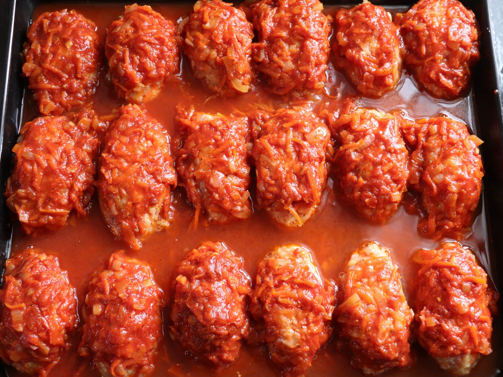 Step 5. Take a deep baking tray and place the formed lazy cabbage rolls on it. Lazy stuffed cabbage — twice as quick