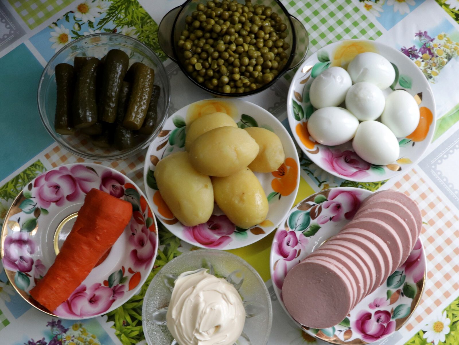 Step 1. For a classic Olivier, boil potatoes, carrot and eggs in their skins until done. Olivier salad