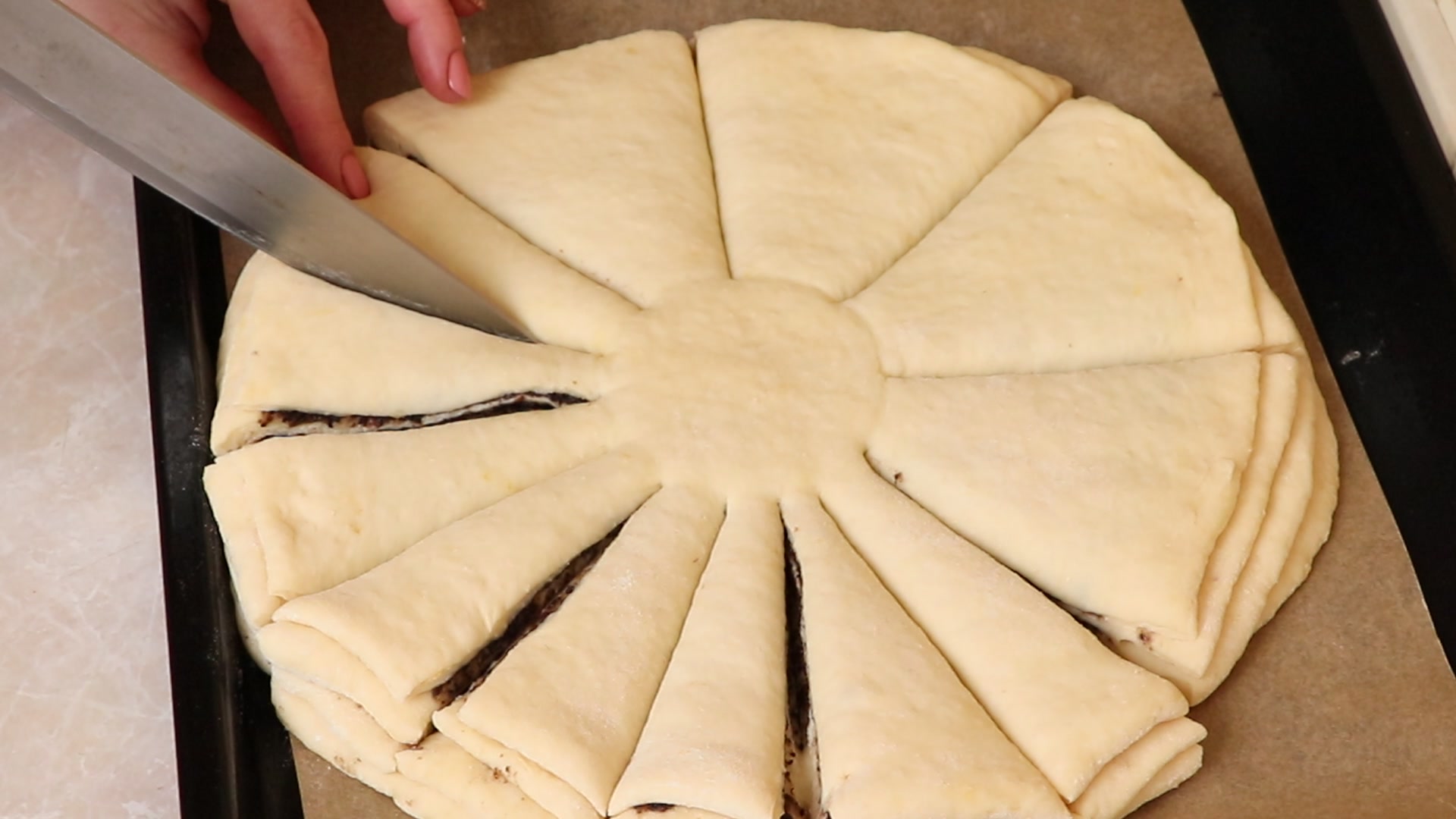 Step 10. Take two neighbouring segments and twist twice in opposite directions; pinch. Poppy-seed flower loaf on cloud-soft