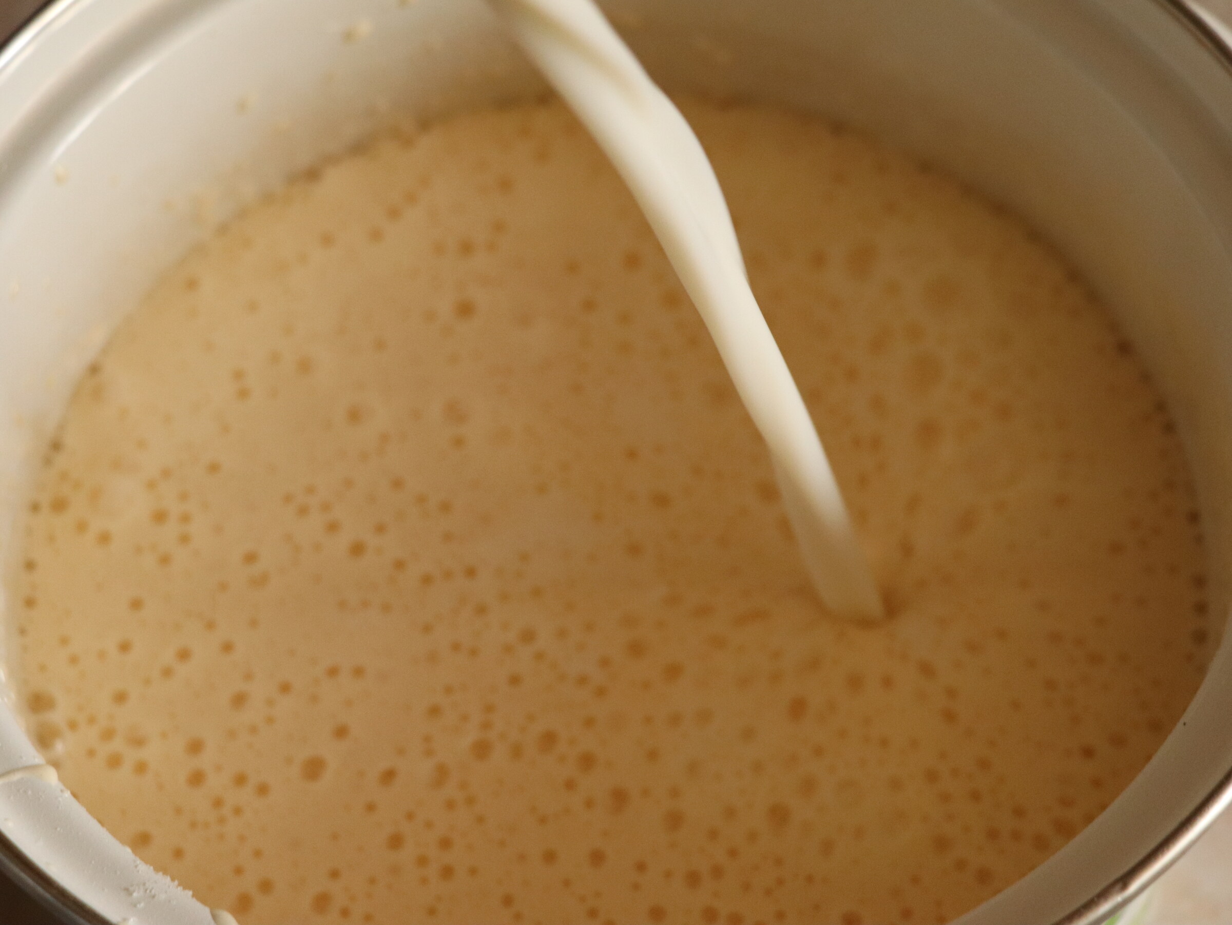 Step 2. Pour milk into beaten eggs with sugar, flour and starch, mix and place on low. Proper crème pâtissière with butter
