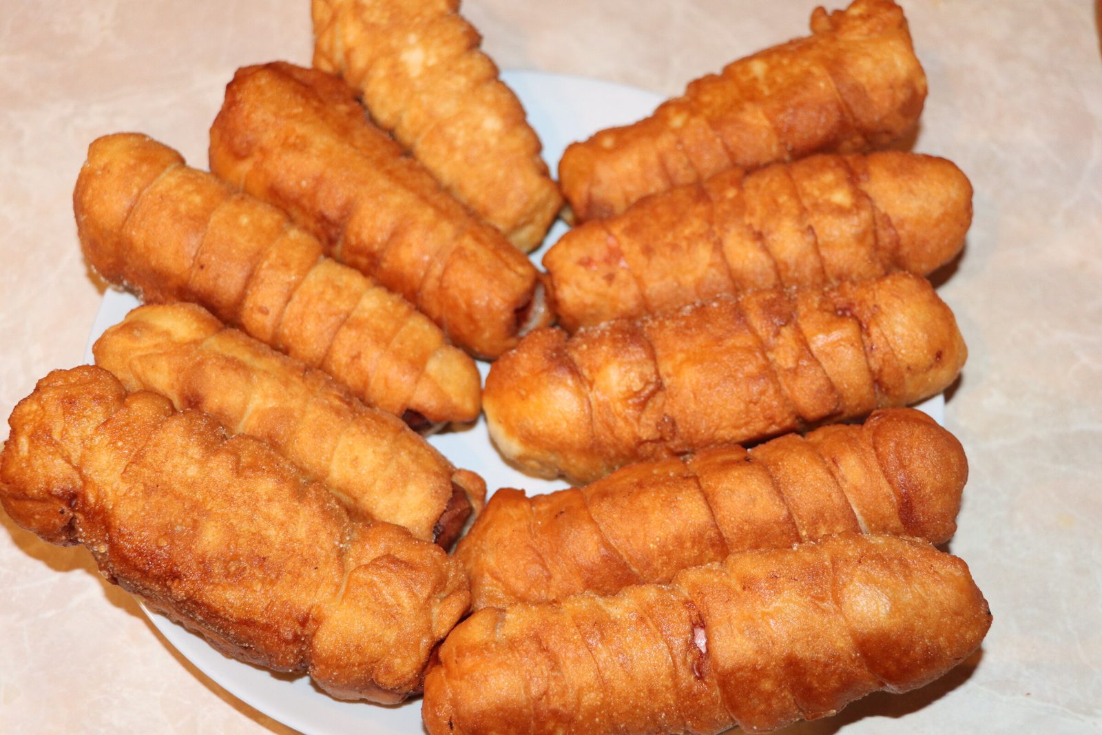 Step 4. Take 1 piece of dough and roll it out into a rectangle. Sausage rolls