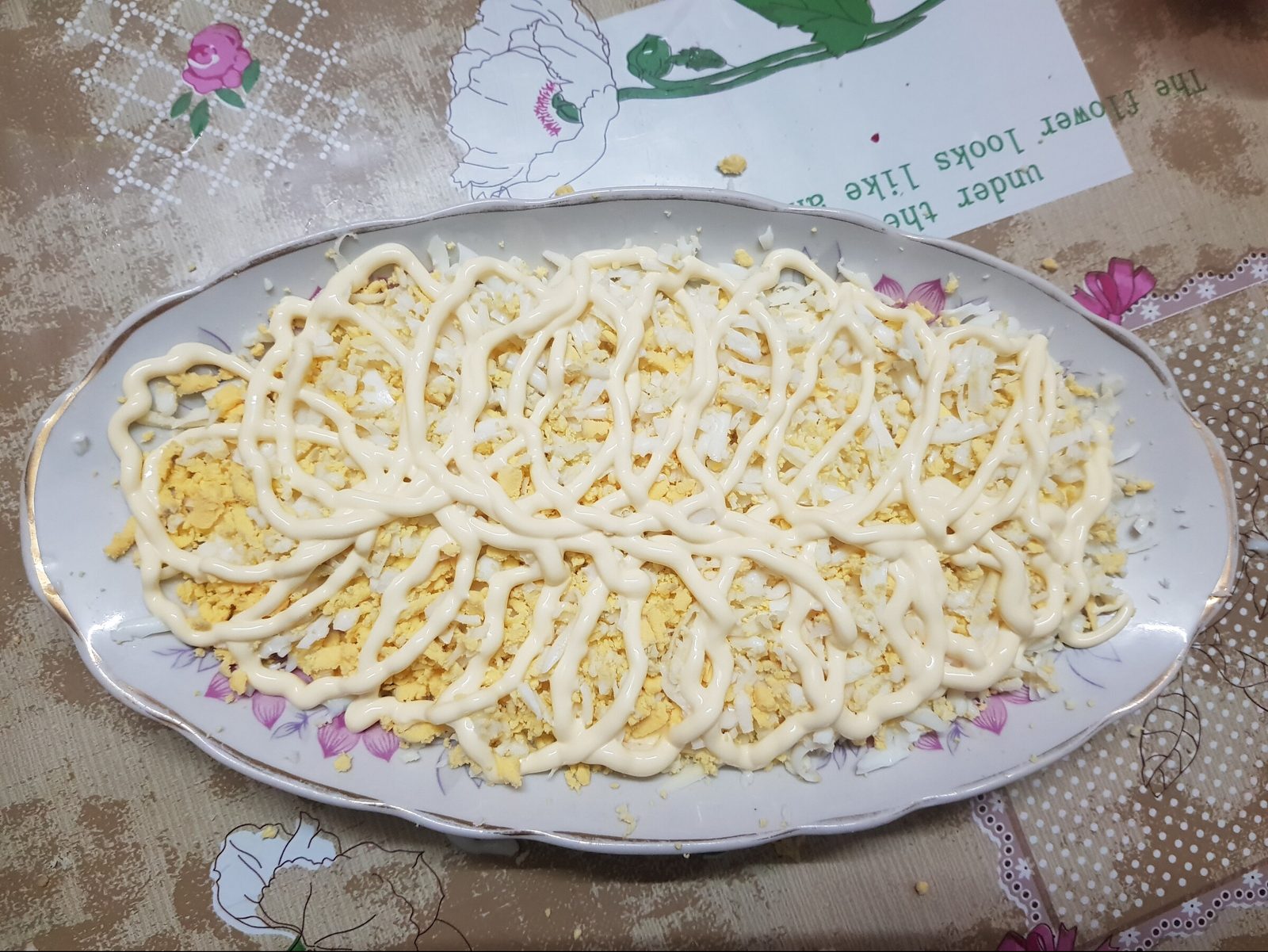 Step 2. The next layer is eggs, three of them on a medium grater. Seafood cocktail salad