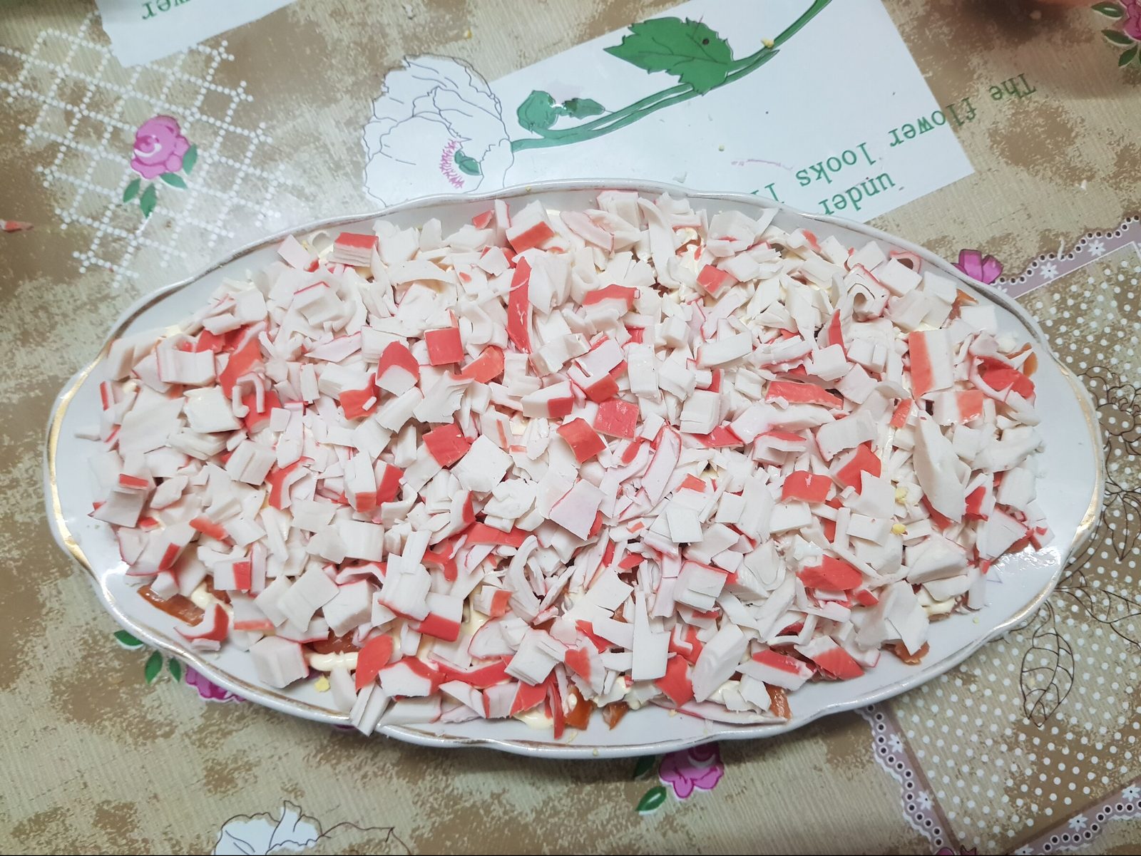Step 4. Then a layer of finely chopped crab sticks. Seafood cocktail salad