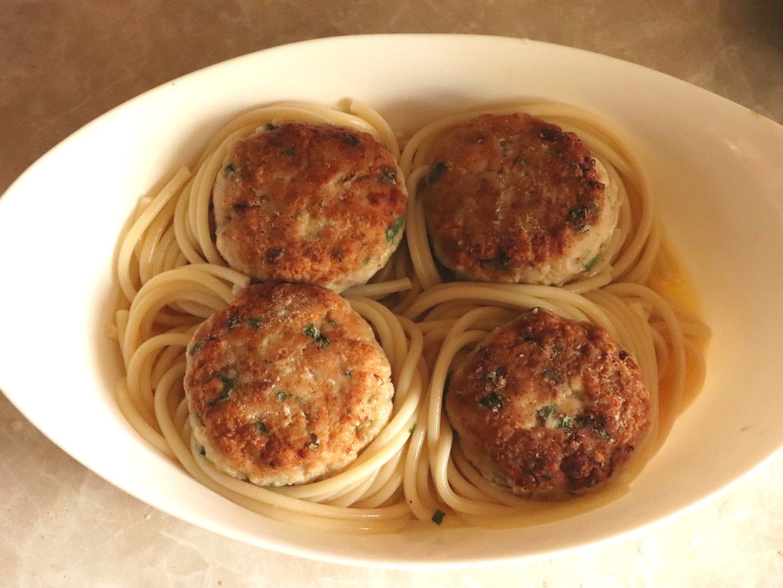 Step 3. A little olive oil on the base, a slice of fresh tomato under each nest. Spaghetti with mince in a spiced tomato