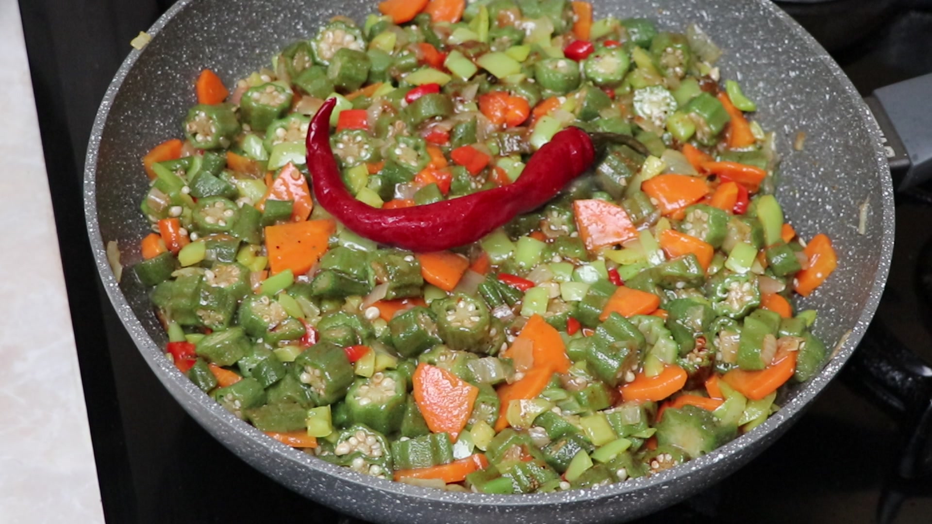 Step 5. Add okra, cut into slices, to the vegetables. Spiced okra stew
