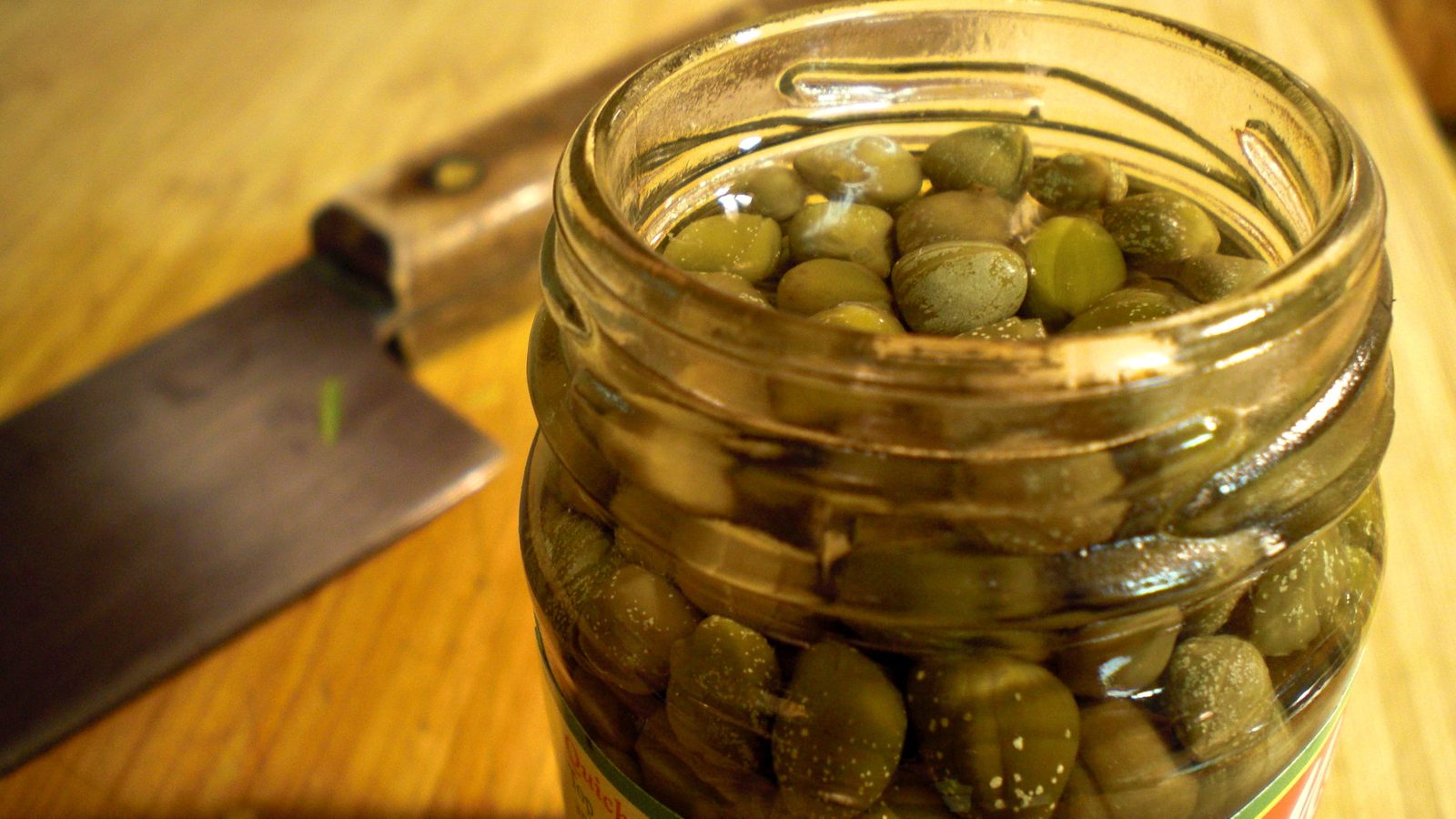 Opened jar of capers I keep under the brine in the cold
