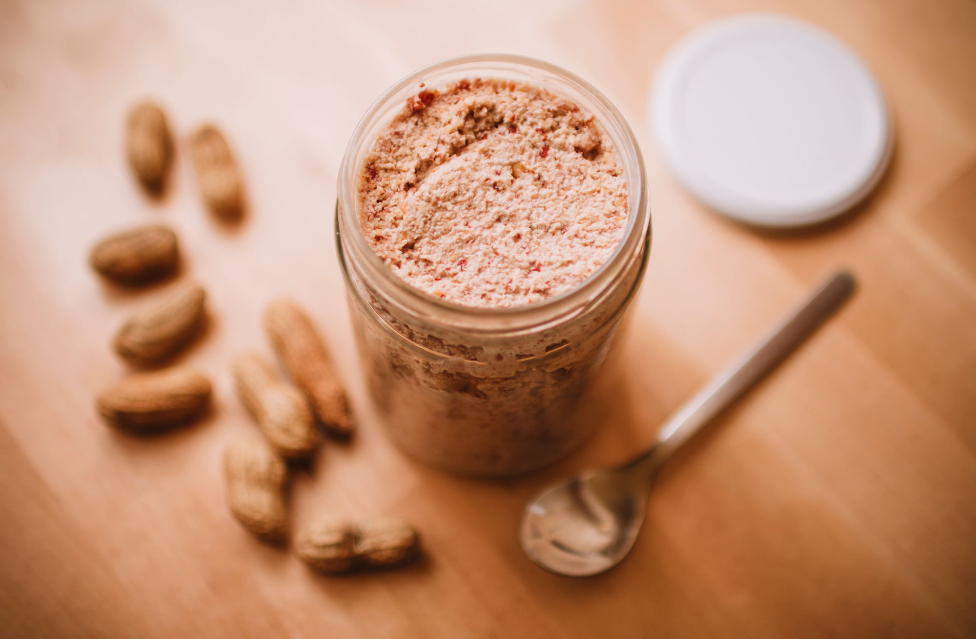 A jar of peanut butter — oil back in, lid wipe, nose