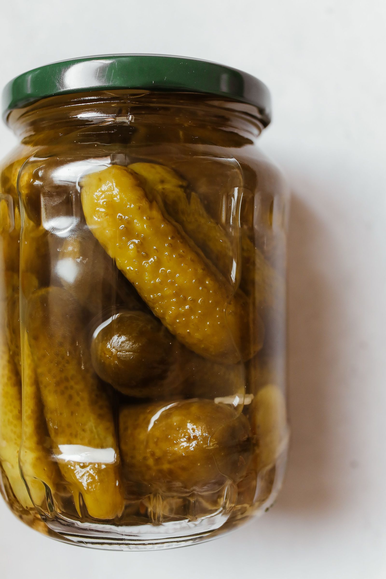 Opened jar of pickled cucumbers I keep under the brine in the cold
