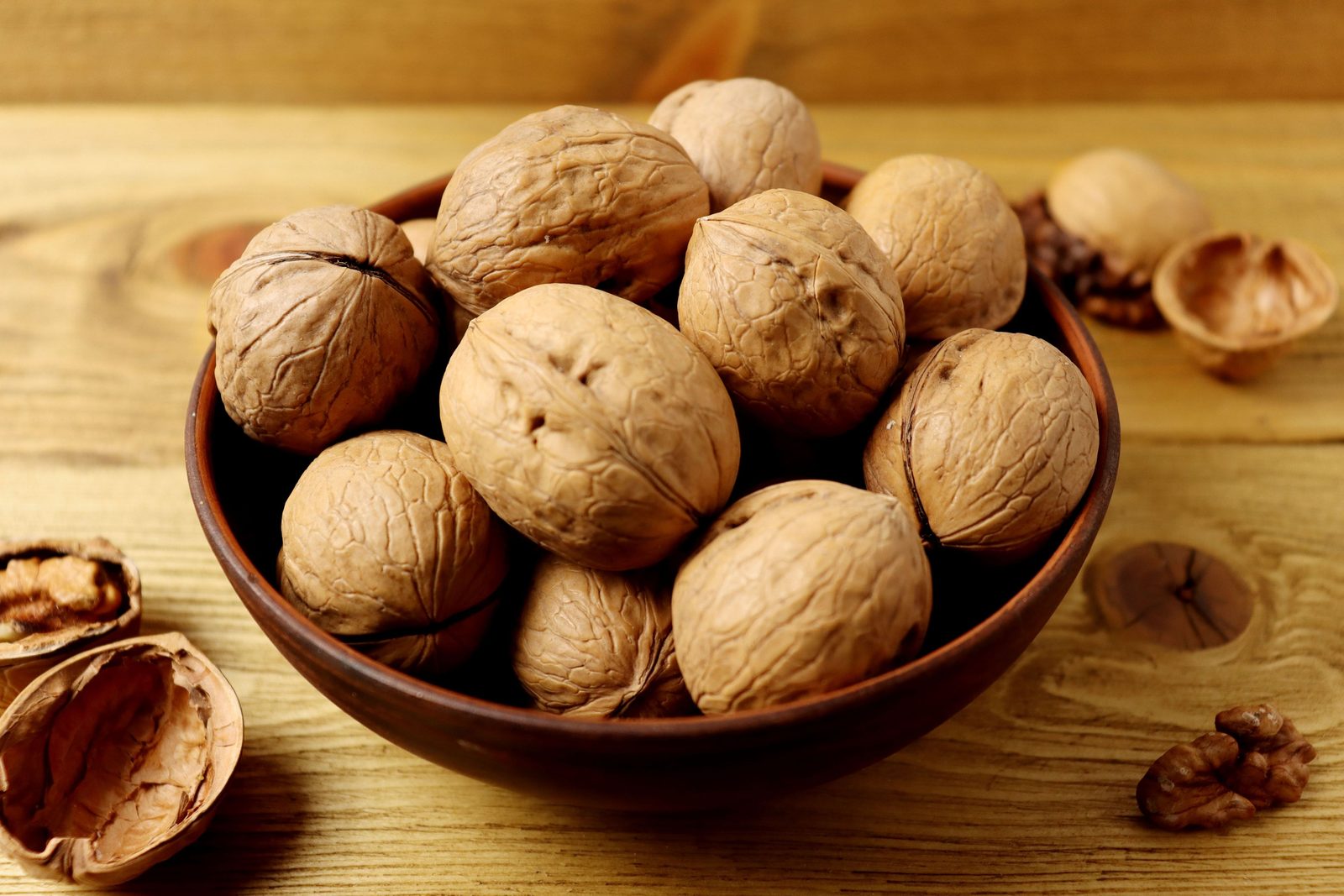 A quiet bowl of walnuts on the table — not a warm cupboard