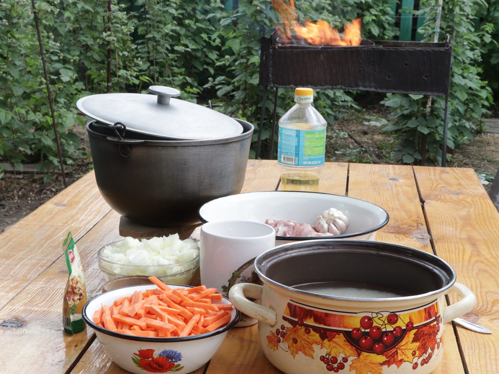 Step 3. We prepare the firewood in advance, light the fire 15 minutes before the start. Plov in a kazan over the fire
