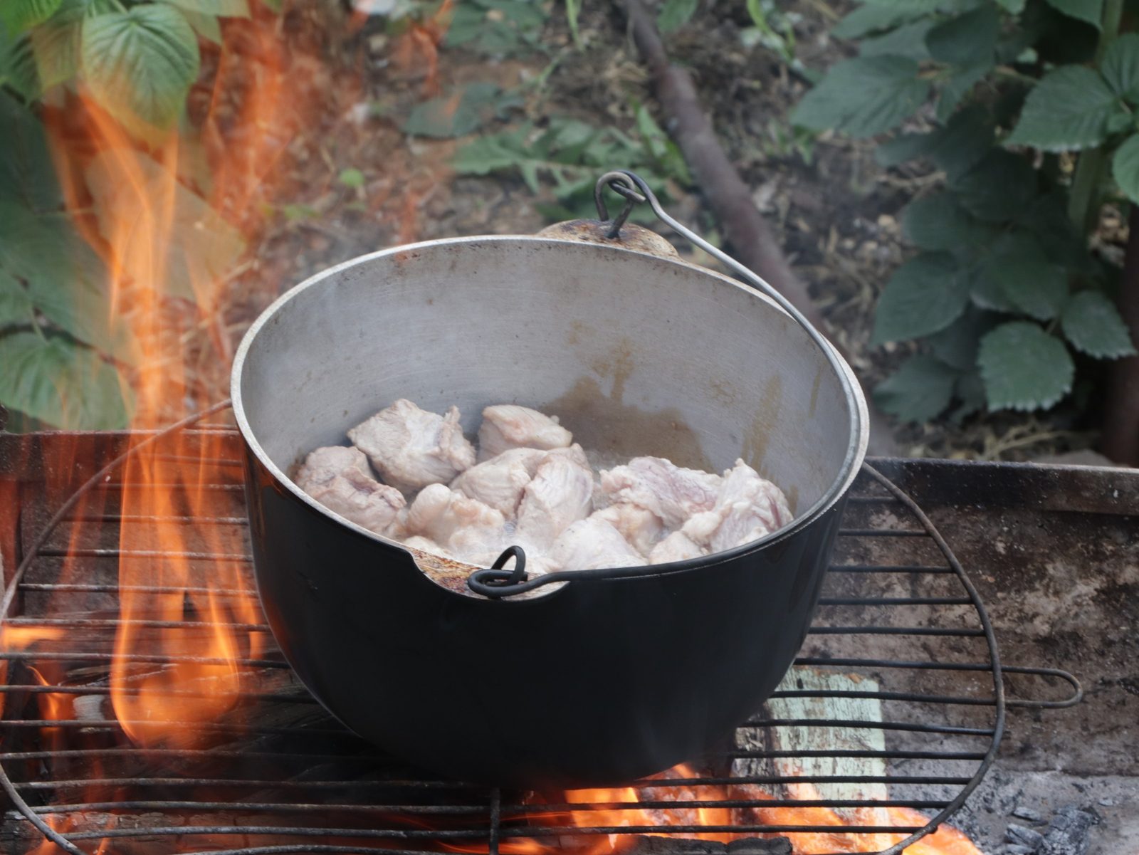 Step 4. We wait until the oil warms up - this will be indicated by the appearance of. Plov in a kazan over the fire